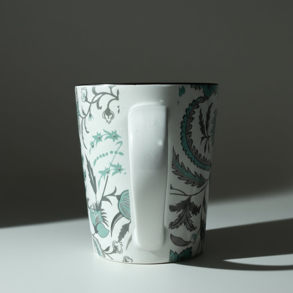 White mug with floral pattern on a wooden surface