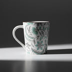 White mug with floral pattern on a wooden surface