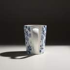 White mug with blue floral patterns on a wooden surface