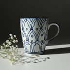 White mug with blue decorative patterns on a wooden surface